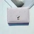 Cute light purple trifold wallet featuring carrot embossing and a small metal bunny ornament - Pink