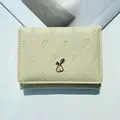 Cream-colored trifold wallet with carrot embossing and a cute bunny metal logo detail - Yellow