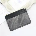Slim black and grey leather card holder with gold zipper and minimalist stitch detail - Black
