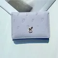 Cute lavender trifold wallet with carrot embossing and rabbit metal clasp for women - Purple