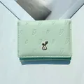 Short mint green women's wallet featuring carrot embossing and a golden rabbit clasp - Green