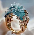 Macro detail of wave-inspired gold ring with blue gradient resin and crystals - Gold Ring