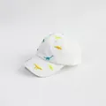 Detail of colorful dinosaur embroidery on a breathable white cotton kids baseball cap - 52cm Adjustable / White