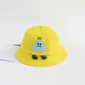 Detail of baby sun hat with cute cartoon character patch on yellow cotton canvas - Medium / Yellow