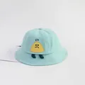 Detail of light blue cotton baby bucket hat featuring a grumpy rice ball cartoon patch - Medium / Light Blue