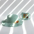 Detail of mint green children straw hat and matching bag with floral daisy accents - Hat And Bag Kids Set / Light Blue