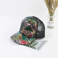 Close-up of a sparkling sequin trucker hat with colorful geometric patterns and black mesh - Green Sequin Black Baseball Cap