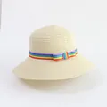 Detailed texture of the woven straw sun hat with a colorful rainbow ribbon decoration - Beige - Colorful Ribbon Bow