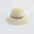 Close-up of beige straw hat featuring colorful geometric pattern band and fine woven texture - Beige - Triangle Ethnic Style