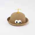 Detailed view of children straw hat featuring plush eyes and a yellow top propeller - Kids / Khaki - Big Eyes Bamboo Dragonfly