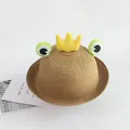 Detailed view of woven straw sun hat for kids with frog eyes and a yellow plush crown - 48-52cm / Khaki