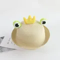 Detail of hand-woven straw hat featuring cartoon frog eyes and yellow plush crown decor - 48-52cm / Beige