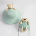 Detail of mint green straw sun hat and matching teddy bear crossbody bag set for kids - Wide Brim Set / Light Blue