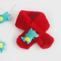Detail of red plush kids scarf with a cute 3D dinosaur cartoon doll and soft faux fur texture - Crocodile Red