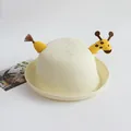 Detailed macro view of cream woven straw sun hat featuring a cute yellow giraffe topper - Giraffe / Cream / One Size