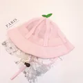 Detailed macro of pink mesh baby sun hat with cute green sprout and adjustable strap - Pink Mesh Hat