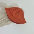 Detailed close-up of rust red corduroy bucket hat texture and minimalist retro design - Small Child 48cm / Orange
