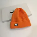 Bright orange cable knit beanie with VE. logo patch and folded cuff for winter fashion - M (56-58cm) / Orange