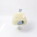Cream knit baby beanie featuring light blue rabbit ears and carrot patch detail - White