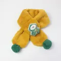 Macro shot of ginger yellow plush kids scarf with green pom poms and cute cartoon mascot - Cedar - Ginger Yellow