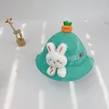 Close-up of mint green knit baby sun hat featuring plush rabbit and carrot decorations - S(46-48cm) / Green