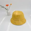 Close-up of yellow cotton fisherman hat with diamond quilting and smile embroidery - S(50cm) / Yellow