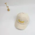 Detail shot of cream fleece baseball cap featuring yellow Chaser embroidery for kids - Milky White