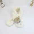 Detailed close-up of white plush kids' scarf with brown cartoon bear and striped fabric paws - Off White