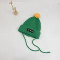Detail of green knit baby hat with yellow pom-pom and embroidered patch strap - S (48-52cm) / Green