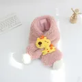 Close-up of pink plush lamb wool scarf featuring a yellow giraffe and white pom-poms - Pink