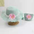 Detail view of woven straw hat and matching bag with mesh flower and cartoon girl doll - Mesh Girl - Green
