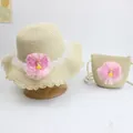 Detail of beige straw hat and matching bag set with lace and pink mesh floral accents - Mesh Girl - Beige