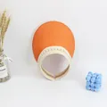 Detail view of the orange straw woven sun visor with elegant white pearl trim decorations - S Kids (48-52CM) / Orange