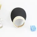 Detail of elegant black and white straw visor with pearl trim and headband design - Black
