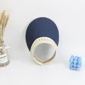 Detail of straw woven visor hat with elegant pearl embellishments and blue texture - Navy Blue