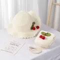 Detail of kids straw sun hat and matching cherry bag set in creamy white finish - Kids Style (Size S) / Cream