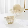 Detail view of beige straw hat and matching round bag with white lace and bow accents - Kids (52cm Hat Only) / Beige (Ruffle)