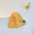 Yellow ribbed knit children's winter hat with a blue smiley face safety pin detail - S (48-53cm) / Yellow (Blue Pin)