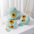 Detail of mint green straw hat and bags set with sunflowers and colorful pom-poms - Round Crossbody Bag / 15x5.5cm / Green