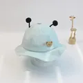 Detail of light blue cotton baby sun hat featuring soft plush pom-pom antennae and lovely patch - Size S (46-48cm) / Light Green