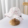 Detailed texture of baby floral sun hat with pink petals and white elastic wind strap - S / Pink Floral