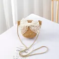Detail of straw woven crossbody bag featuring a large white lace bow and shoulder strap - Natural Wheat - Lace Bow Decoration