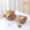 Detailed view of woven straw sun hat and matching crossbody bag with cute cat ears - Kids Hat / Khaki