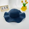 Detailed weave pattern of a navy blue wide-brim straw hat with elegant wavy edges - Navy Blue