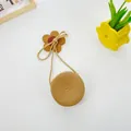 Detail of straw woven round bag for kids with decorative wooden flower and rope strap - Round Bag (12x6.5cm) / Khaki