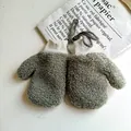 Macro detail of plush sherpa mittens with ribbed cuffs and convenient neck lanyard - M / Green