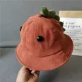 Detail of brick red corduroy kids bucket hat featuring cute green dinosaur fins and 3D eyes - Orange