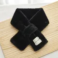 Detail of black plush cross scarf showing soft faux fur texture and woven brand label - Black