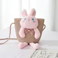 Detail of a girls' straw crossbody bag featuring a pink plush rabbit with blue eyes - Pink Bag Pink Rabbit