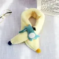 Detail of plush beige kids scarf with a green cartoon crocodile and colorful pom-poms - Crocodile Style (Cream Yellow)